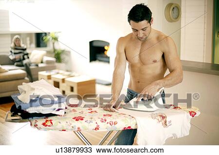 Stock Image - Man ironing. Fotosearch