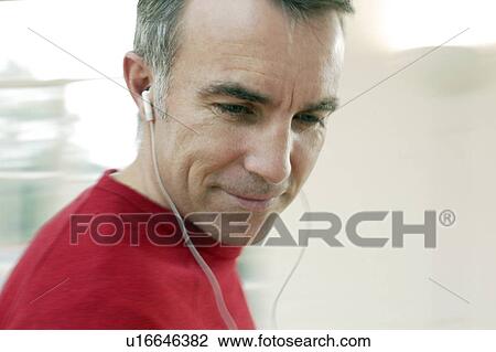 Stock Image - Man listening to music. Fotosearch