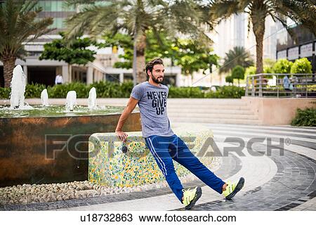 Man training, doing warm ups in park, Dubai, United Arab Emirates View Large Photo Image Stock Image - Man training, doing warm ups in park, Dubai, United Arab Emirates. Fotosearch