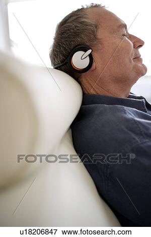 Stock Photo - Man using headphones. Fotosearch
