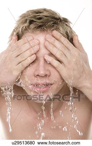 Stock Image - Man washing his face. Fotosearch