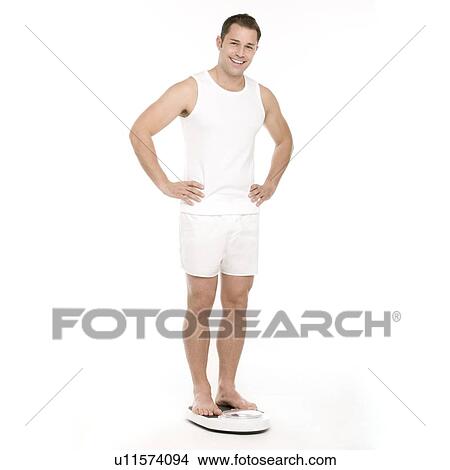 Man weighing himself View Large Photo Image Picture - Man weighing himself. Fotosearch