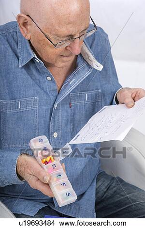 Man with pill organiser View Large Photo Image Picture - Man with pill organiser. Fotosearch