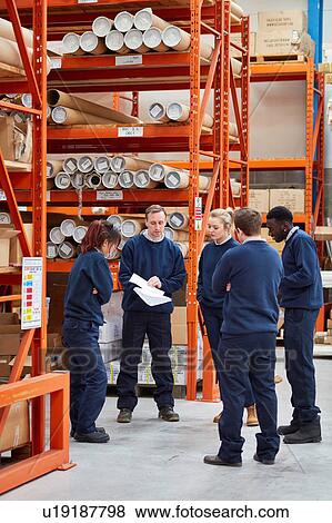 Stock Photo - Manager training factory work team in factory warehouse. Fotosearch