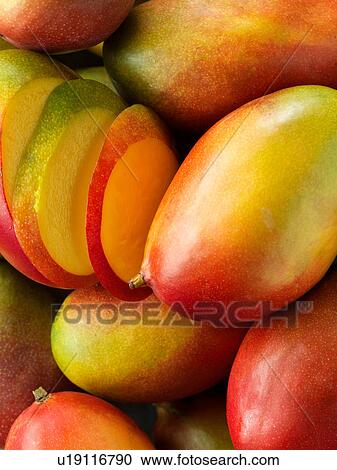 Mangoes, whole and sliced, close-up View Large Photo Image Stock Image - Mangoes, whole and sliced, close-up. Fotosearch