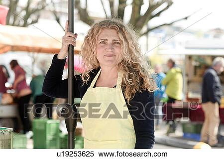 Stock Photography - Market trader taking break. Fotosearch