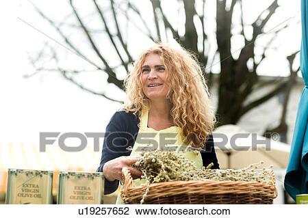 Market trader with basket of olive branch View Large Photo Image Stock Image - Market trader with basket of olive branch. Fotosearch