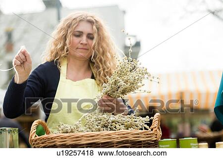 Market trader with basket of olive branch View Large Photo Image Stock Photo - Market trader with basket of olive branch. Fotosearch