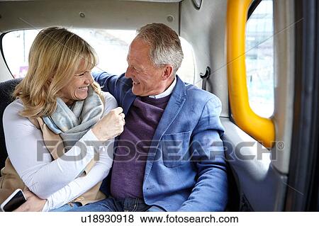 Mature dating couple en route in black cab backseat View Large Photo Image Stock Photo - Mature dating couple en route in black cab backseat. Fotosearch