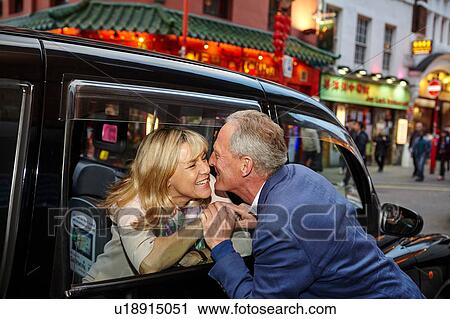 Mature dating couple kissing farewell at black cab window in China Town, London, UK View Large Photo Image Stock Image - Mature dating couple kissing farewell at black cab window in China Town, London, UK. Fotosearch