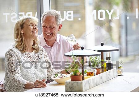 Mature dating couple laughing at restaurant lunch, London, UK View Large Photo Image Stock Photography - Mature dating couple laughing at restaurant lunch, London, UK. Fotosearch