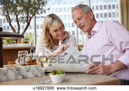 Mature dating couple reading menu at restaurant table View Large Photo Image Stock Photography - Mature dating couple reading menu at restaurant table. Fotosearch