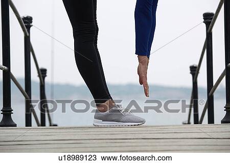 Mature woman outdoors, exercising, touching toes, low section View Large Photo Image Stock Image - Mature woman outdoors, exercising, touching toes, low section. Fotosearch