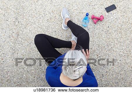 Mature woman sitting outdoors, hand weights, water and smartphone beside her, elevated view View Large Photo Image Stock Photograph - Mature woman sitting outdoors, hand weights, water and smartphone beside her, elevated view. Fotosearch