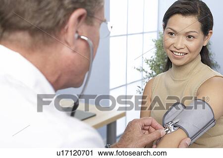 Stock Image - Measuring blood pressure. Fotosearch