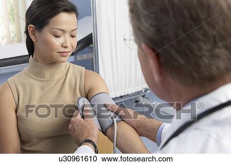 Stock Image - Measuring blood pressure. Fotosearch
