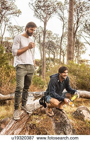 Stock Photo - Men drinking coffee in forest, Deer Park, Cape Town, South Africa. Fotosearch