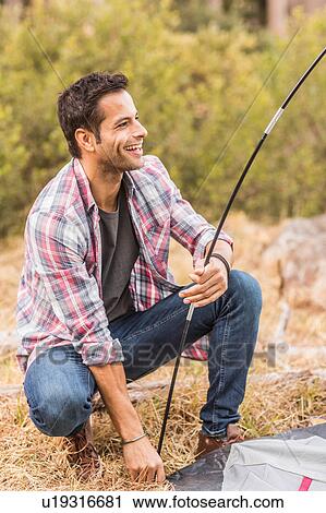Mid adult man putting up tent rod in forest, Deer Park, Cape Town, South Africa View Large Photo Image Stock Image - Mid adult man putting up tent rod in forest, Deer Park, Cape Town, South Africa. Fotosearch