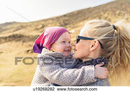 Stock Image - Mother and daughter hugging, face to face, Hveragerdi, Iceland. Fotosearch