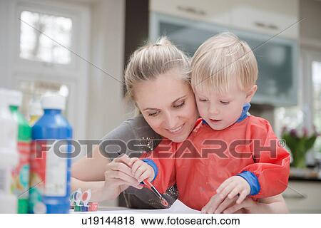 Mother and son doing painting together View Large Photo Image Stock Photo - Mother and son doing painting together. Fotosearch