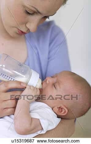 Mother bottle-feeding baby boy View Large Photo Image Stock Photo - Mother bottle-feeding baby boy. Fotosearch