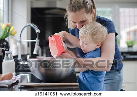 Mother helping son bake cake View Large Photo Image Stock Image - Mother helping son bake cake. Fotosearch