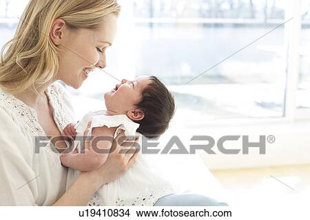 Mother holding baby View Large Photo Image Picture - Mother holding baby. Fotosearch
