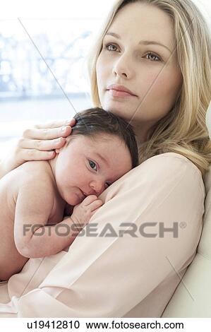 Stock Image - Mother holding baby. Fotosearch