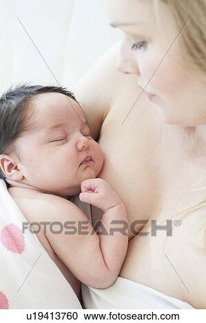 Stock Image - Mother holding baby. Fotosearch