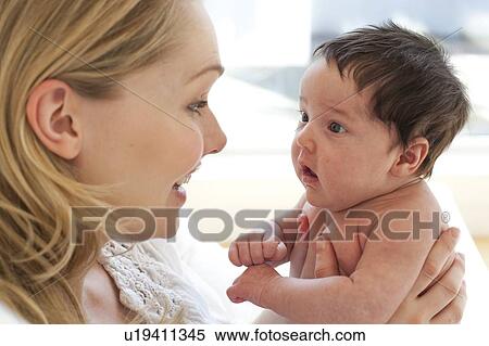 Stock Photography - Mother holding baby. Fotosearch