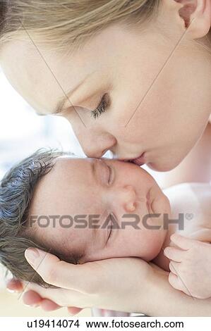 Picture - Mother kissing baby. Fotosearch