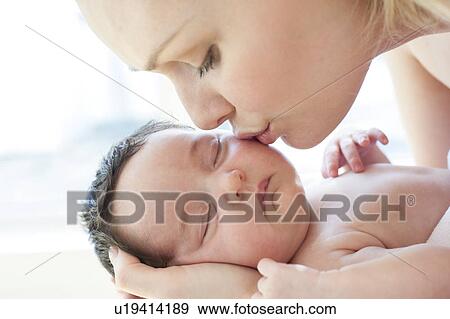 Mother kissing baby View Large Photo Image Stock Photo - Mother kissing baby. Fotosearch