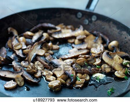 Mushrooms frying in butter in frying pan, close-up View Large Photo Image Stock Image - Mushrooms frying in butter in frying pan, close-up. Fotosearch