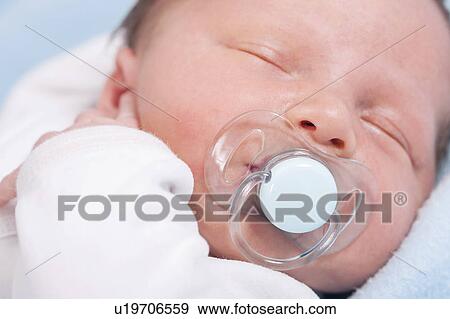 Newborn baby boy with dummy View Large Photo Image Stock Photo - Newborn baby boy with dummy. Fotosearch