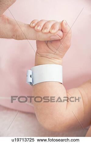 Newborn baby gripping parent's finger View Large Photo Image Stock Photography - Newborn baby gripping parent's finger. Fotosearch