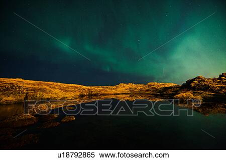 Stock Photography - Northern Lights over lake, Straumsvik, Iceland. Fotosearch
