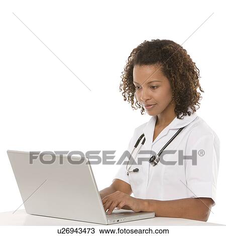 Stock Image - Nurse using a laptop. Fotosearch