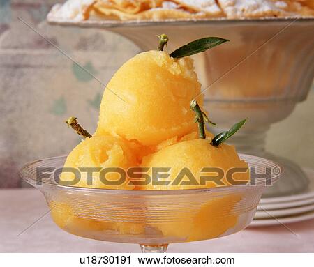 Orange sorbet dessert in glass dish, close-up View Large Photo Image Stock Image - Orange sorbet dessert in glass dish, close-up. Fotosearch
