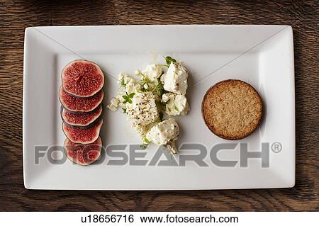 Overhead view of feta, figs and crackers on cheese board View Large Photo Image Stock Photograph - Overhead view of feta, figs and crackers on cheese board. Fotosearch