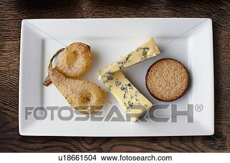 Overhead view of stilton, poached pears and crackers on cheese board View Large Photo Image Picture - Overhead view of stilton, poached pears and crackers on cheese board. Fotosearch