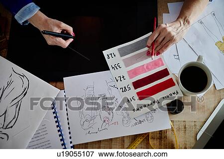 Overhead view of woman hands sketching fashion design on computerised sketch pad View Large Photo Image Stock Photo - Overhead view of woman hands sketching fashion design on computerised sketch pad. Fotosearch