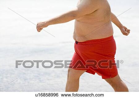 Stock Photograph - Overweight man walking. Fotosearch