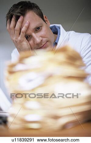 Stock Image - Overworked doctor. Fotosearch