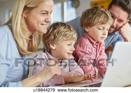 Stock Photo - Parents and sons using laptop. Fotosearch