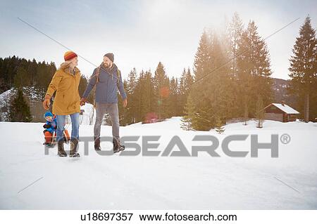 Parents pulling sons on toboggan in snow landscape, Elmau, Bavaria, Germany View Large Photo Image Stock Photo - Parents pulling sons on toboggan in snow landscape, Elmau, Bavaria, Germany. Fotosearch