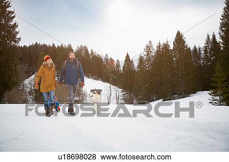 Parents pulling sons on toboggan in snow covered landscape, Elmau, Bavaria, Germany View Large Photo Image Stock Photo - Parents pulling sons on toboggan in snow covered landscape, Elmau, Bavaria, Germany. Fotosearch