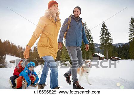 Parents pulling sons on toboggan in winter landscape, Elmau, Bavaria, Germany View Large Photo Image Stock Photography - Parents pulling sons on toboggan in winter landscape, Elmau, Bavaria, Germany. Fotosearch