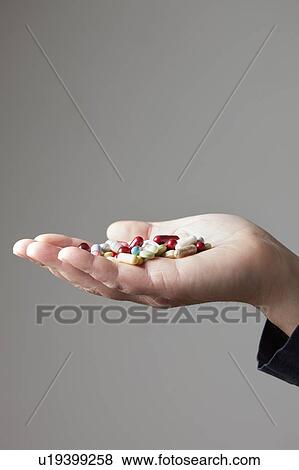 Person holding pills on palm of hand View Large Photo Image Stock Photo - Person holding pills on palm of hand. Fotosearch