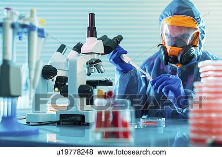 Person working in microbiology lab View Large Photo Image Stock Photo - Person working in microbiology lab. Fotosearch