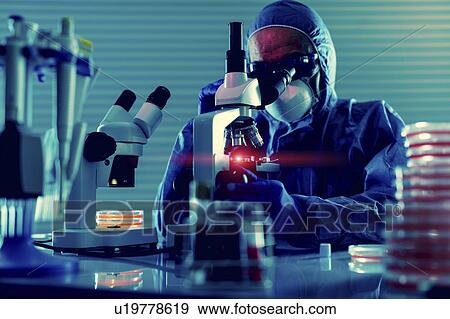 Stock Photo - Person working in microbiology lab. Fotosearch